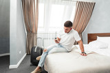 Man using smartphone in hotel room