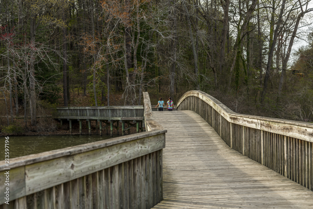 Jogging on a wooden bridge path Jogging on a wooden bridge path