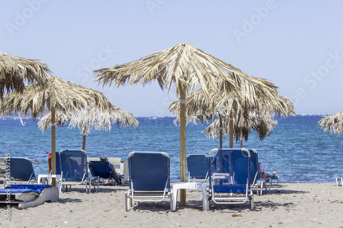 Perspective shot of blue sunbed near open sea at Petra in Lesvos