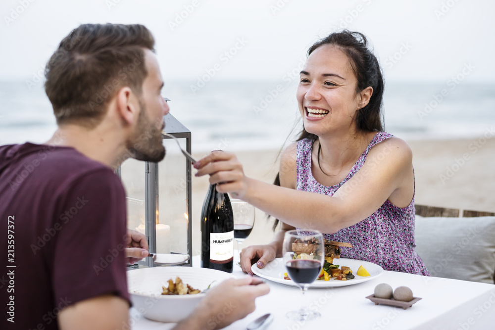 Couple enjoying a romantic dinner at the beach Couple enjoying a romantic dinner at the beach
