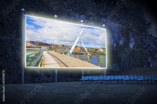 Urban skyline of Derry city (also called Londonderry) in northern Ireland with the famous "Peace Bridge" (Europe - Northern Ireland) - Outdoor cinema concept image