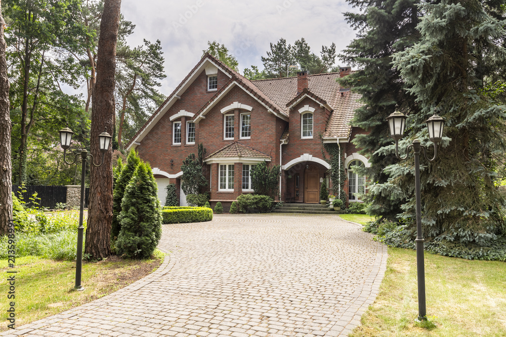 Stone driveway to house in english architectural style in the forest. Real photo Stone driveway to house in english architectural style in the forest. Real photo