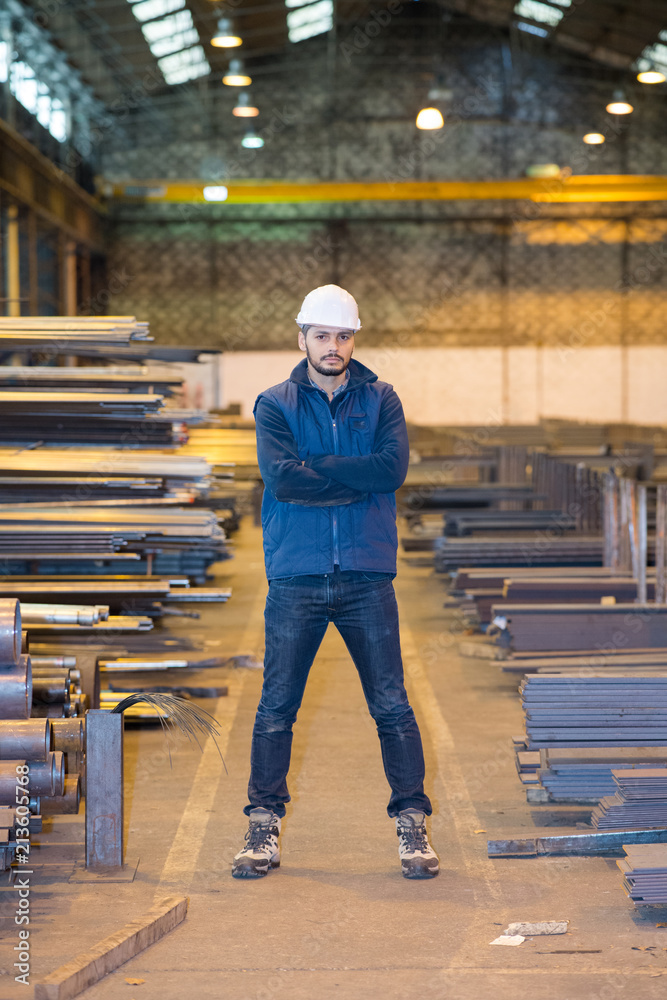 man crossing arms in warehouse man crossing arms in warehouse
