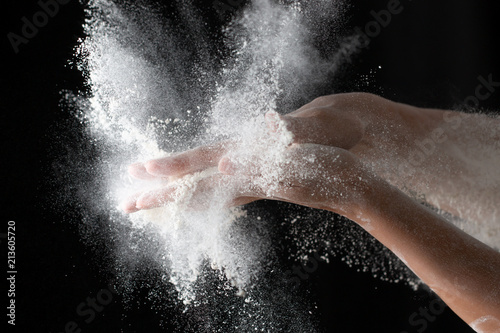hands with flour on a black background © studybos