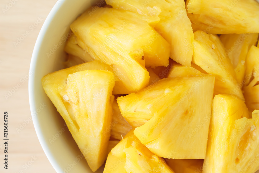 Pineapple slice on a plate placed on a wooden table. Pineapple slice on a plate placed on a wooden table.