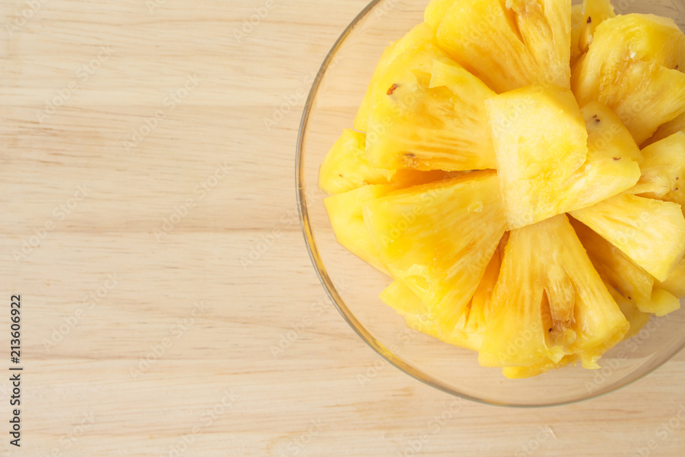 Pineapple slice on a plate placed on a wooden table. Pineapple slice on a plate placed on a wooden table.