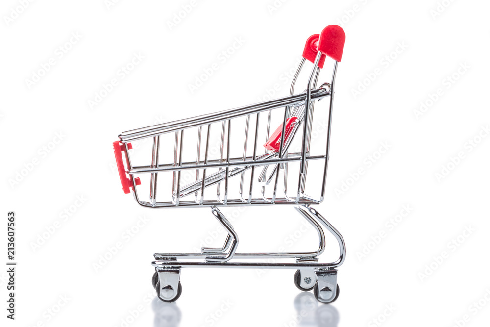 Red shopping cart trolley isolated on white background. Side view. Shopping concept.