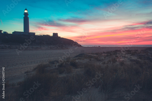 Colorful sky at magic sunset at Trafalgar lighthouse in Zahora beach  Cadiz. Summer holidays  travel vacation concepts
