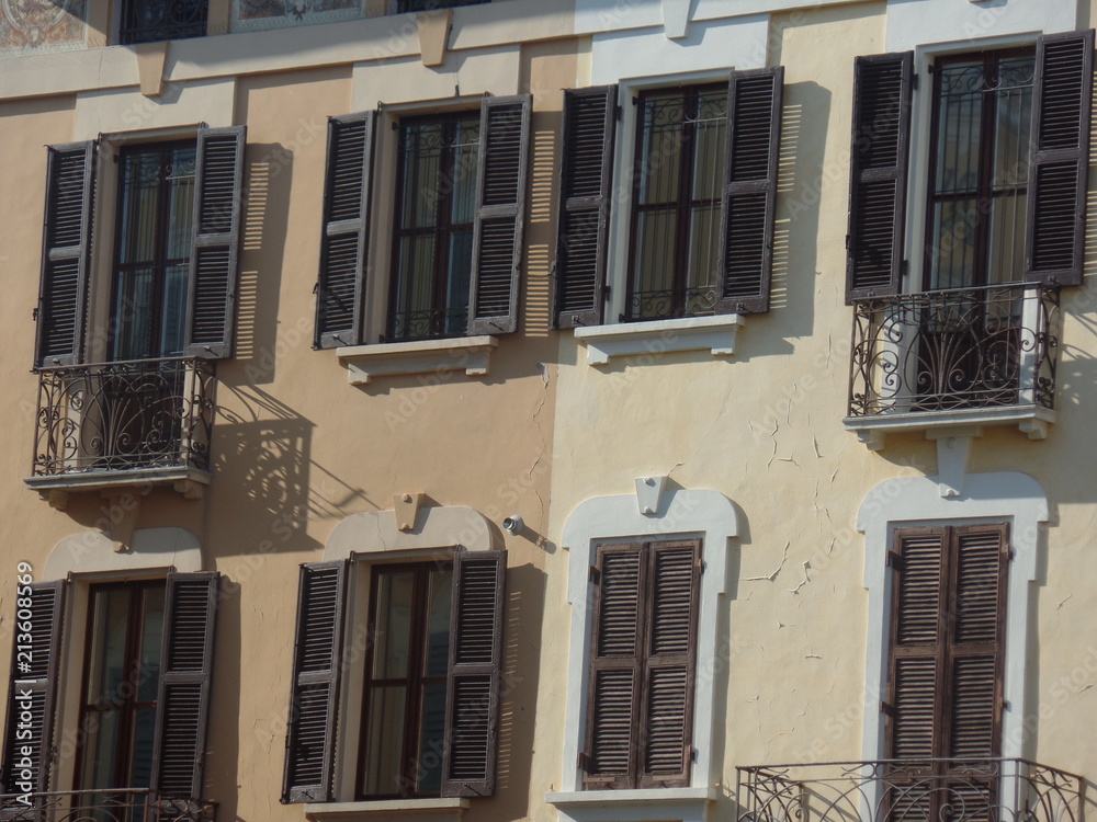 Typical Italian style building with brown shutters