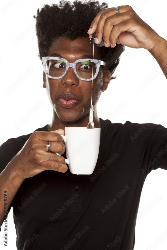 Portrait of young african american man holding a mug with tea on white background Portrait of young african american man holding a mug with tea on white background