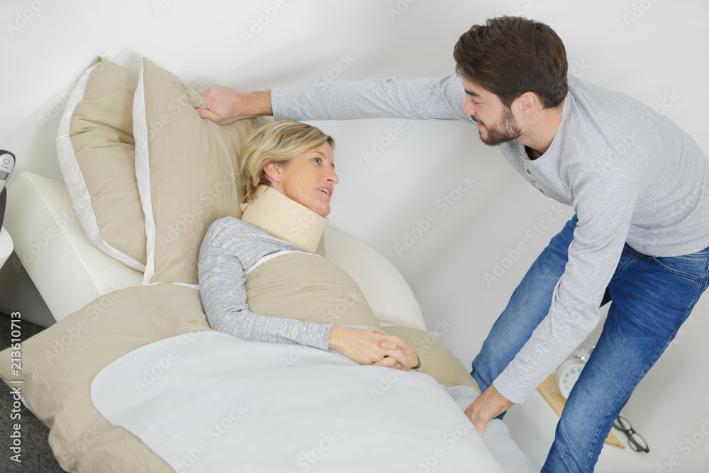 Fototapeta premium son helps his mum suffering with a cervical collar