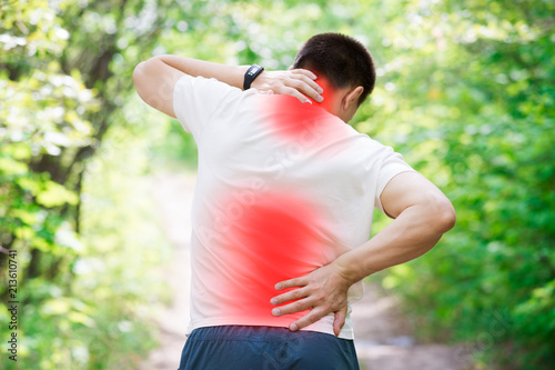 Man with back pain, injury while running, trauma during workout