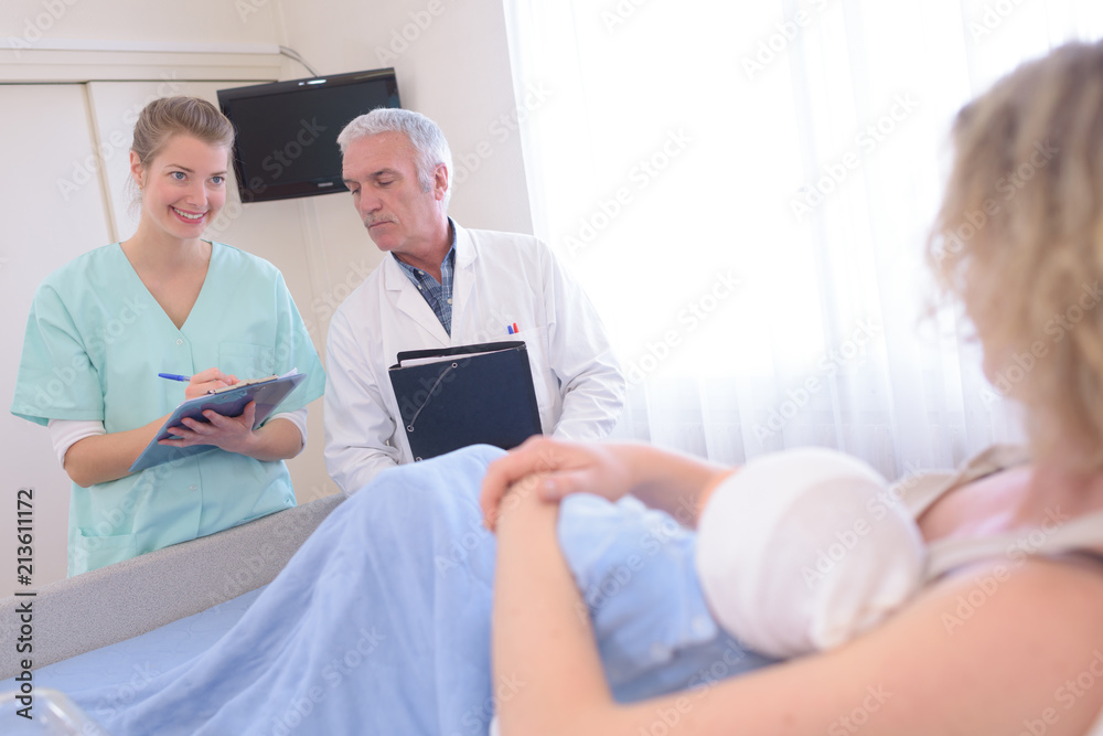 Fototapeta premium newborn baby in delivery room with mum doctor nurse