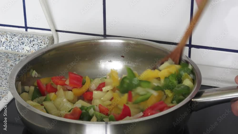 Fried pepper on a frying pan. Fried colorful vegetables on a frying pan. Fried pepper on a frying pan. Fried colorful vegetables on a frying pan.