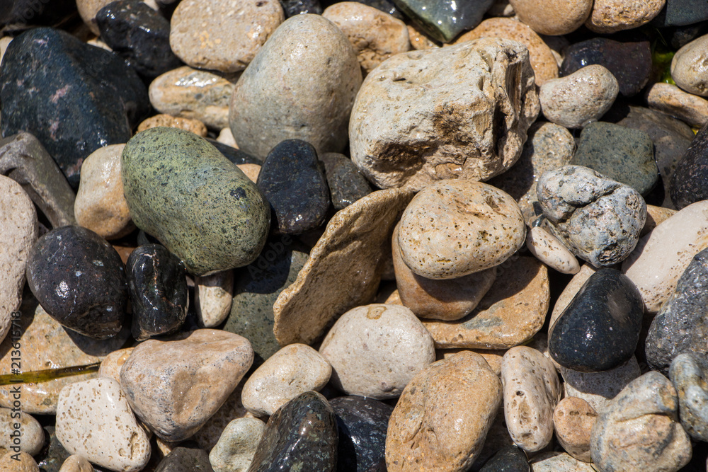 The surface of the pebble on the beach. Little rock texture. The surface of the pebble on the beach. Little rock texture.