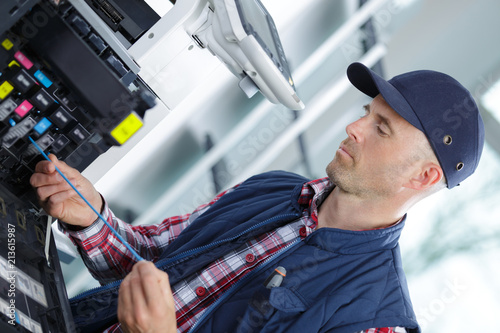 Картината върху платно technician man repairing photocopy machine