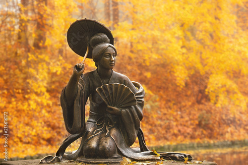 Fotografie BILA TSERKVA, UKRAINE - October 18th, 2017: Statue of chinese woman with umbrell