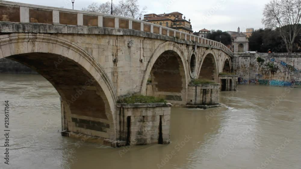 Rome - View of swollen Tiber river and a Medieval Bridge Rome - View of swollen Tiber river and a Medieval Bridge