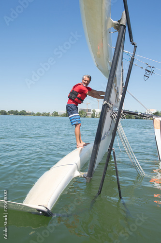 salior trying to right his catamaran after capsize © auremar