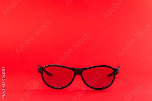 Modern fashionable and office spectacles isolated on red background
