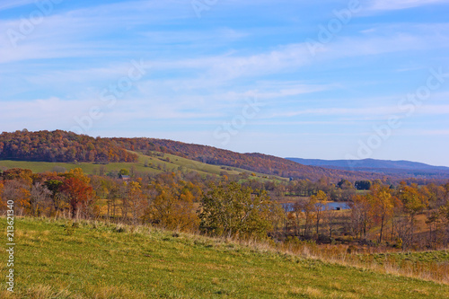 Countryside landscape in autumn colors with pond. Fields and forests of Virginia countyside.