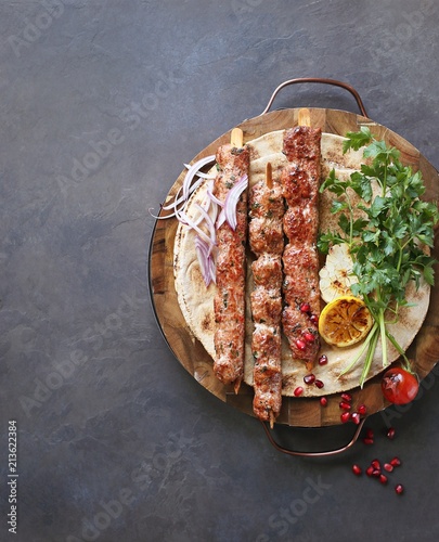     Kebab. Traditional middle eastern, arabic or mediterranean meat kebab with vegetables and herbs. Overhead view, copy space