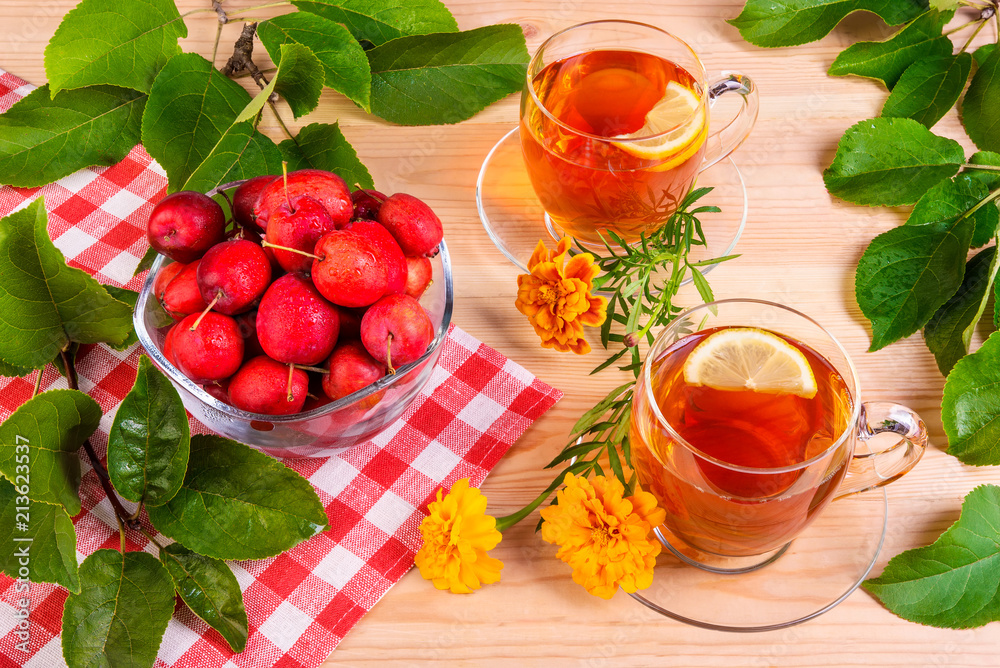 Herbal tea with lemon, paradise apples and marigold, top view Herbal tea with lemon, paradise apples and marigold, top view