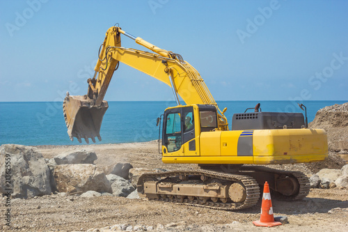 excavator works on the sea coast 