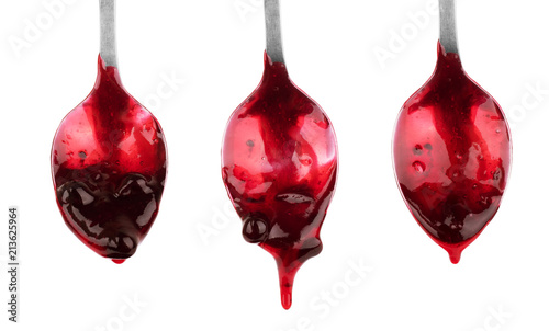 Set of spoons with jam on white background photo