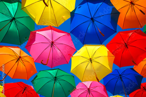 Lots of colorful umbrellas in the sky. City decoration