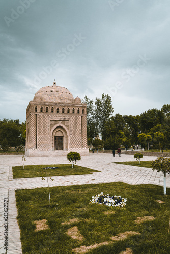 Samanid Mausoleum with tree and sky in Bukhara, Uzbekistan photo