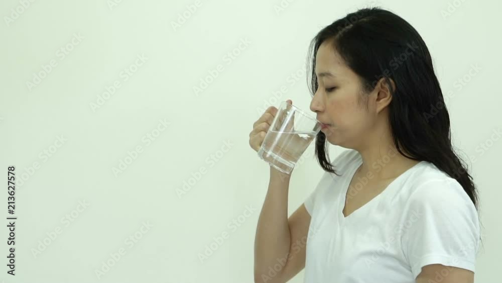 Asian woman drinking water 8 cup a day for healthy skin and body slow motion video Asian woman drinking water 8 cup a day for healthy skin and body slow motion video