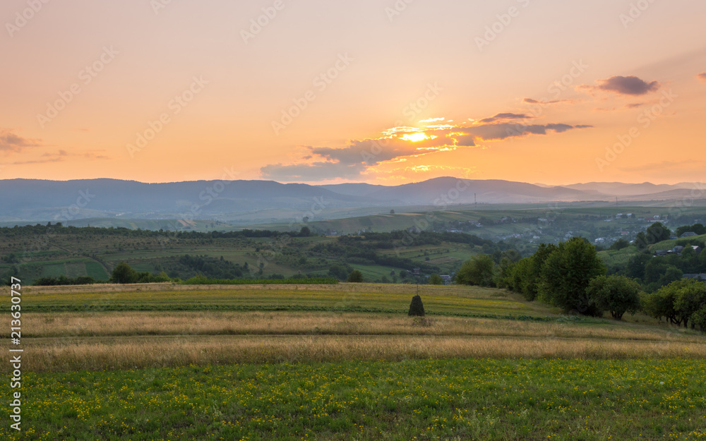 Soft Sky Rural Mountain and Meadow Sunset with Sun in Clouds