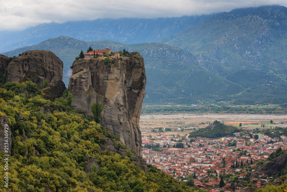 Magnificent autumn landscape. Monastery Holy Trinity, Meteora, Greece. UNESCO world heritage Site. Epic landscape with temple at the edge of cliff at dramatic sky background.