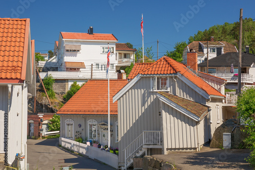 Typical white houses in Kragero, built against the mountain side photo