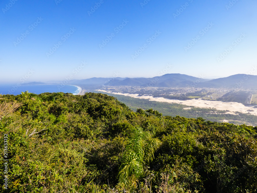 A view of Mocambique beach, sand dunes and urban area from the top of Morro das Aranhas (Florianopolis, Brazil)