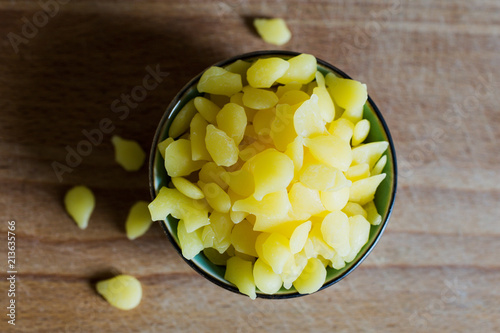 Obraz na płótnie pure yellow beeswax granulate pellets for homemade cosmetic beauty products w salonie