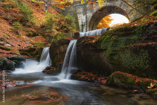 Autumn waterfalls near Sitovo  Plovdiv  Bulgaria. Beautiful cascades of water with fallen yellow leaves.