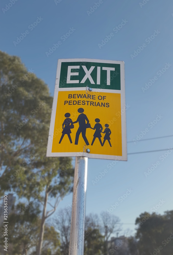 Exit and Beware of pedestrian sign
