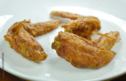  crispy fried chicken wing with herb on white plate 