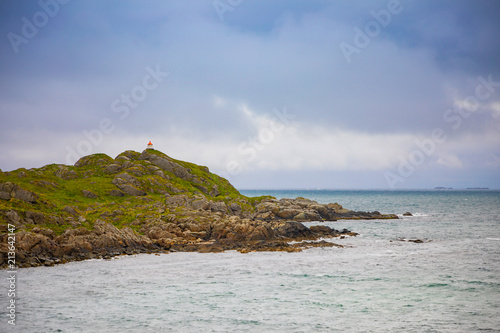 Lighthouse next to Rambergstranda beach in Lofoten Islands, Norway photo