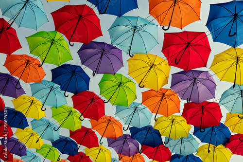 Multicolored umbrellas against the sky, street decorated