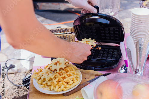 Cooking waffles in iron waffle maker.