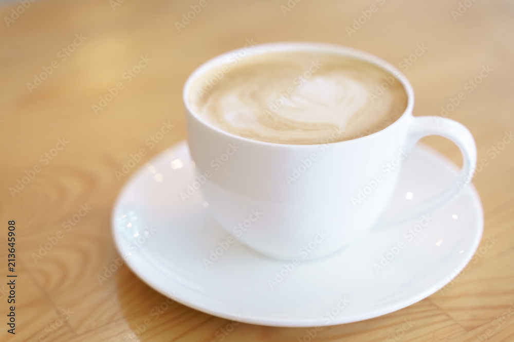 Cup of coffee with latte art pattern milk foam