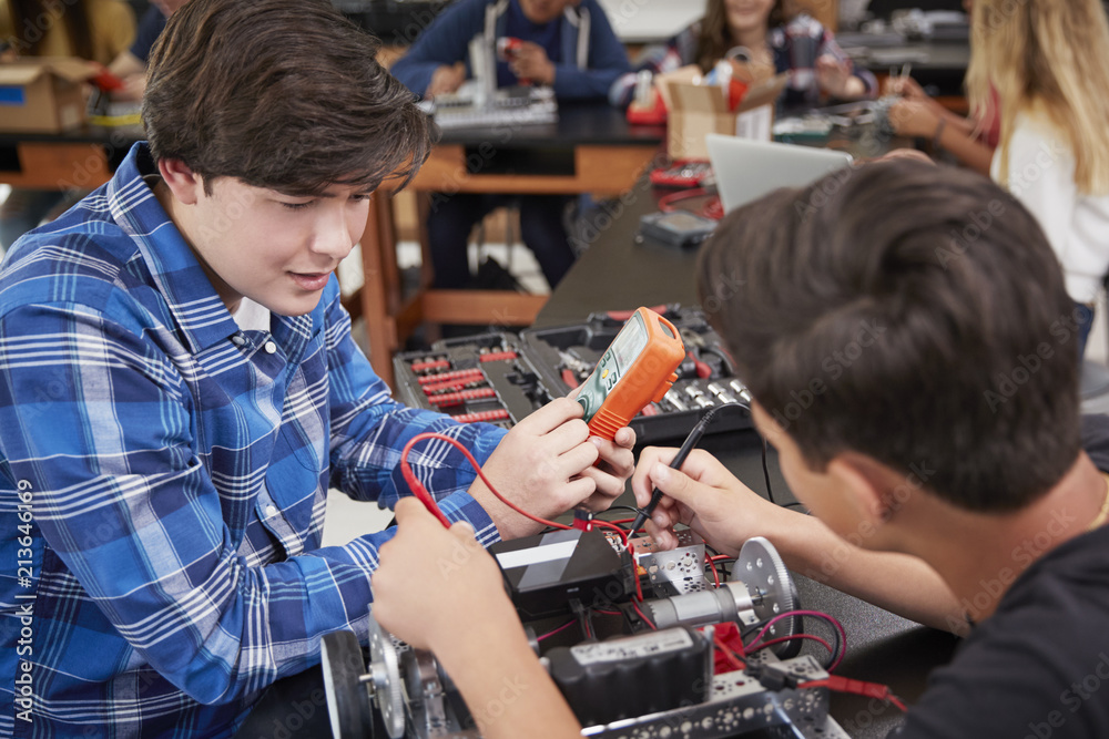 Two Male Pupils Building Robotic Vehicle In Science Lesson Two Male Pupils Building Robotic Vehicle In Science Lesson