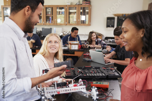 Teacher With Female Pupils Building Robotic Vehicle In Science Lesson © Monkey Business