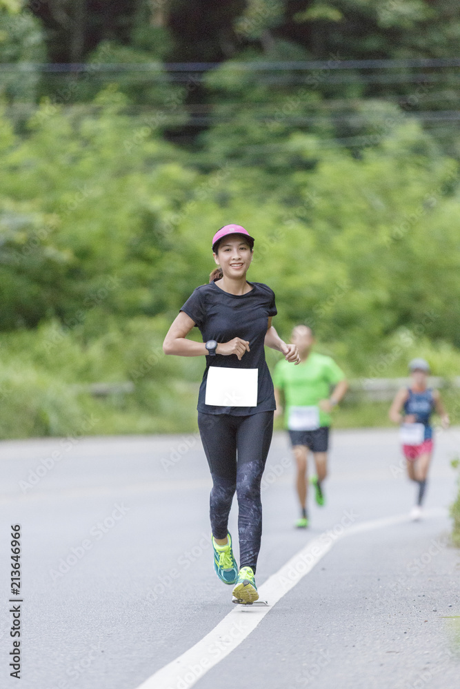 Woman asian Marathon running race, Run up the mountain road. Woman asian Marathon running race, Run up the mountain road.