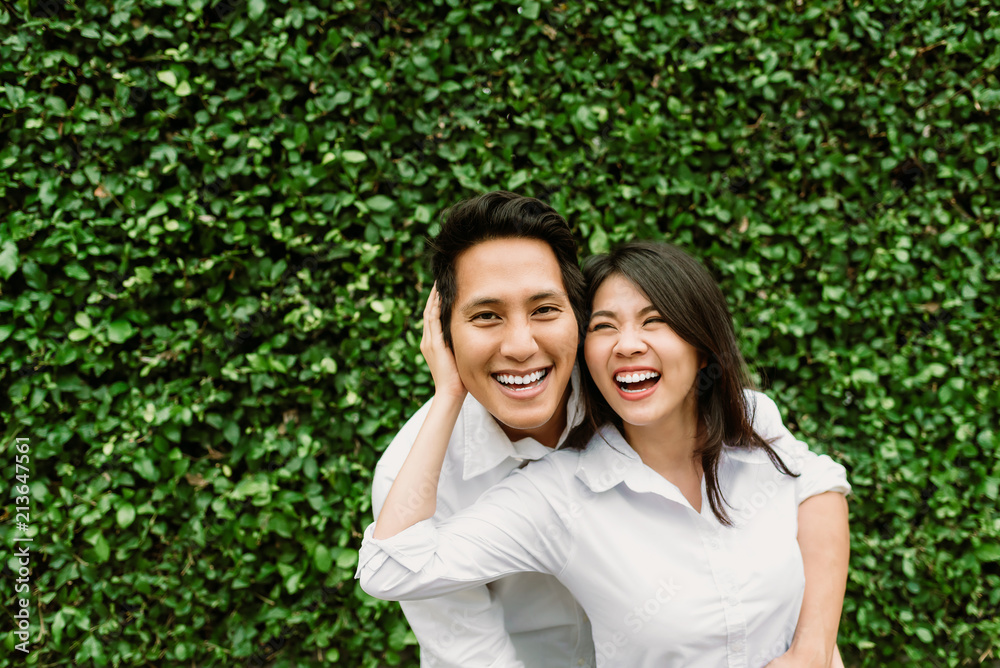 Happy Asian couple in love smiling while hug each other outdoor Happy Asian couple in love smiling while hug each other outdoor
