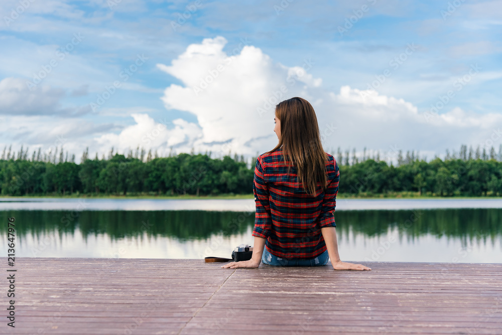 Young beautiful hipster woman sitting on the lake pier, Relaxed atmosphere, summer. Young beautiful hipster woman sitting on the lake pier, Relaxed atmosphere, summer.