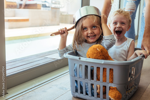 Vászonkép Kids rides in a laundry basket